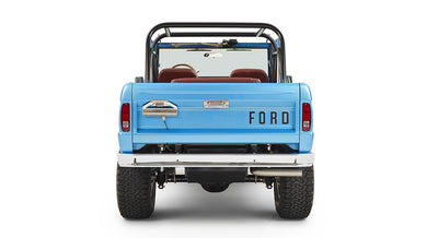 Rear view of sky blue Classic Ford Bronco with roll cage and FORD lettering on tailgate