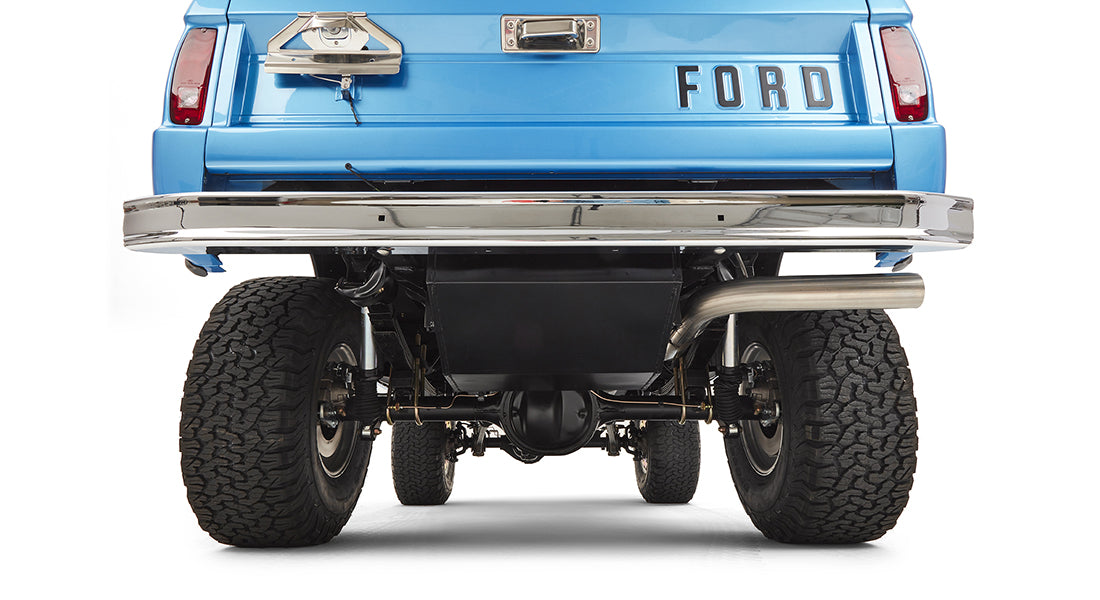 Undercarriage and rear bumper of sky blue Classic Ford Bronco with visible suspension and exhaust