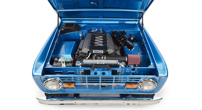 Front view of sky blue Classic Ford Bronco with open hood showing clean engine bay