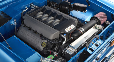 Closer view of 5.0-liter engine and air intake in engine bay of sky blue Classic Ford Bronco