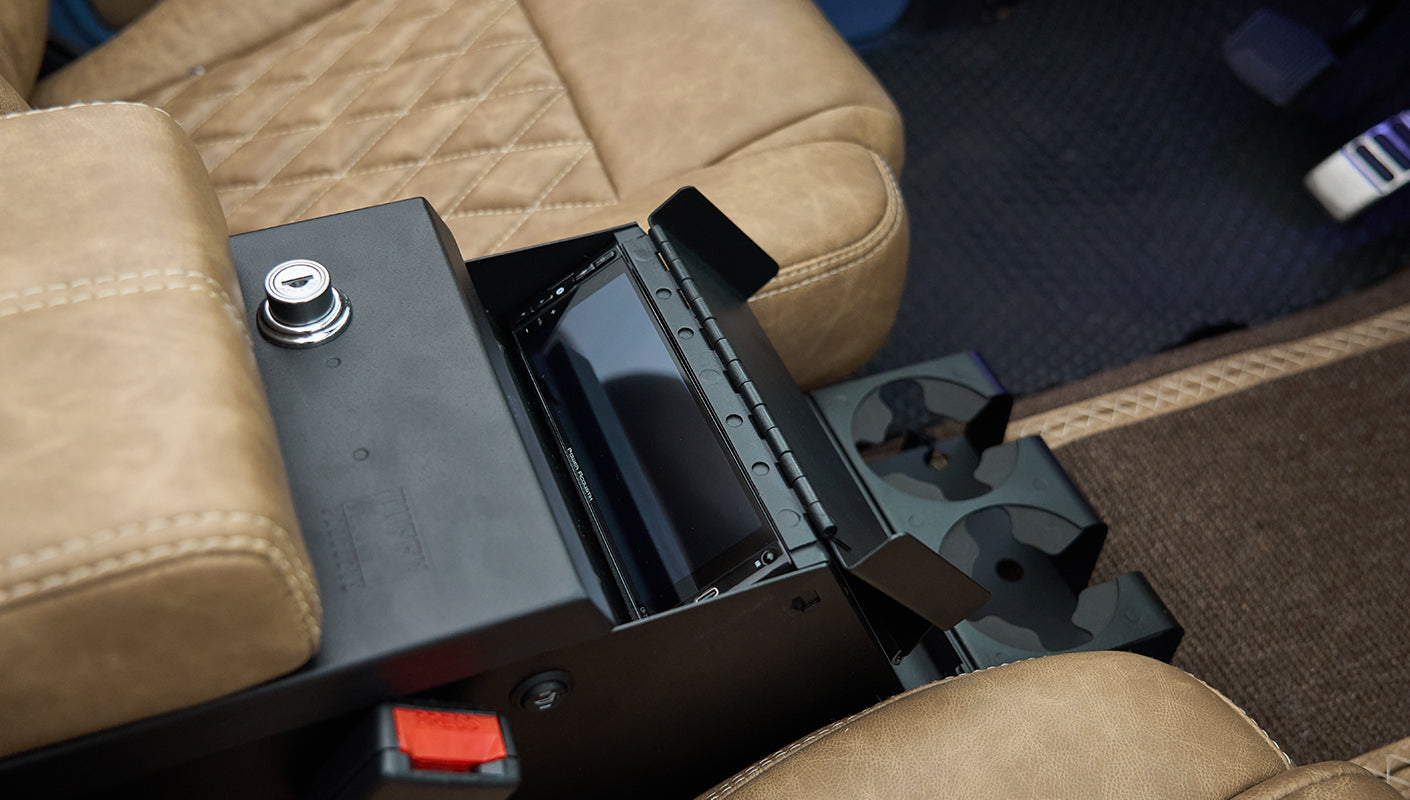 Open center console revealing a touchscreen stereo unit inside a Classic Ford Bronco.