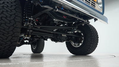 Front suspension and steering components visible underneath a Classic Ford Bronco.