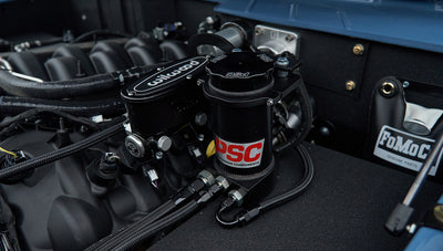 Close-up of black Wilwood and PSC steering components in engine bay
