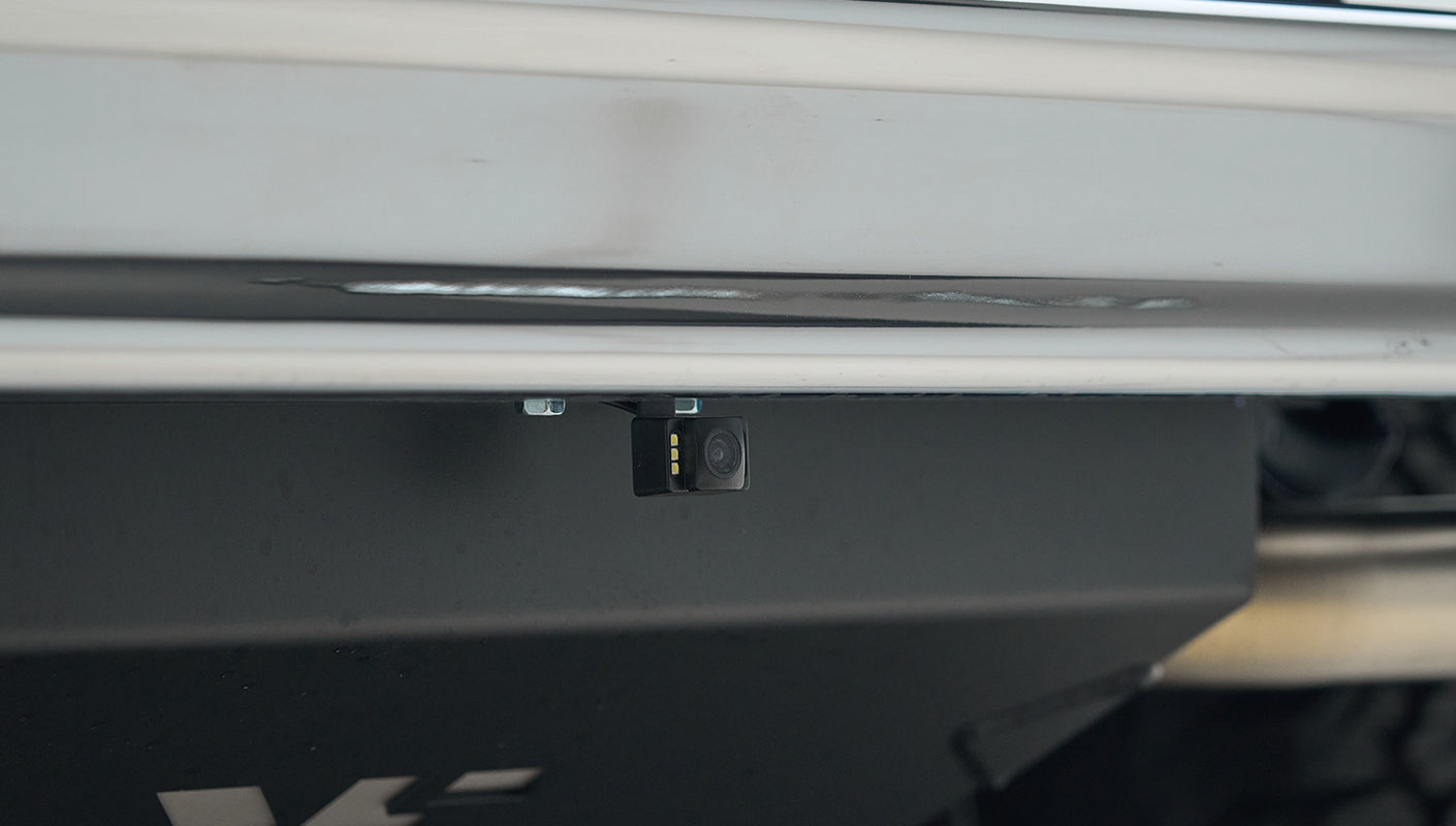 Small camera mounted under rear bumper of blue Classic Ford Bronco