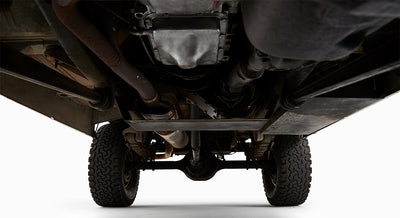 Close-up undercarriage view of green Classic Ford Bronco showing exhaust and drivetrain