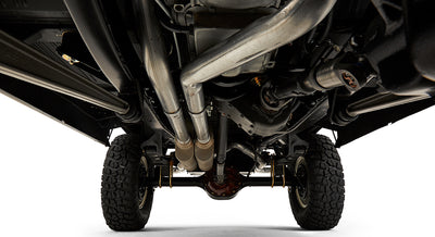 Undercarriage view showing exhaust pipes, axle, and suspension of Classic Ford Bronco