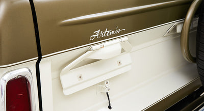 Rear side of Classic Ford Bronco showing part of white two-tone body with Artemis lettering and open fuel door