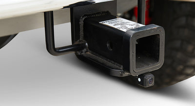 Rear tow hitch receiver with a small backup camera attached, mounted on a Classic Ford Bronco