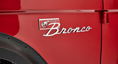 Close-up of red vehicle exterior with Classic Ford Bronco Sport badge featuring bronco horse emblem