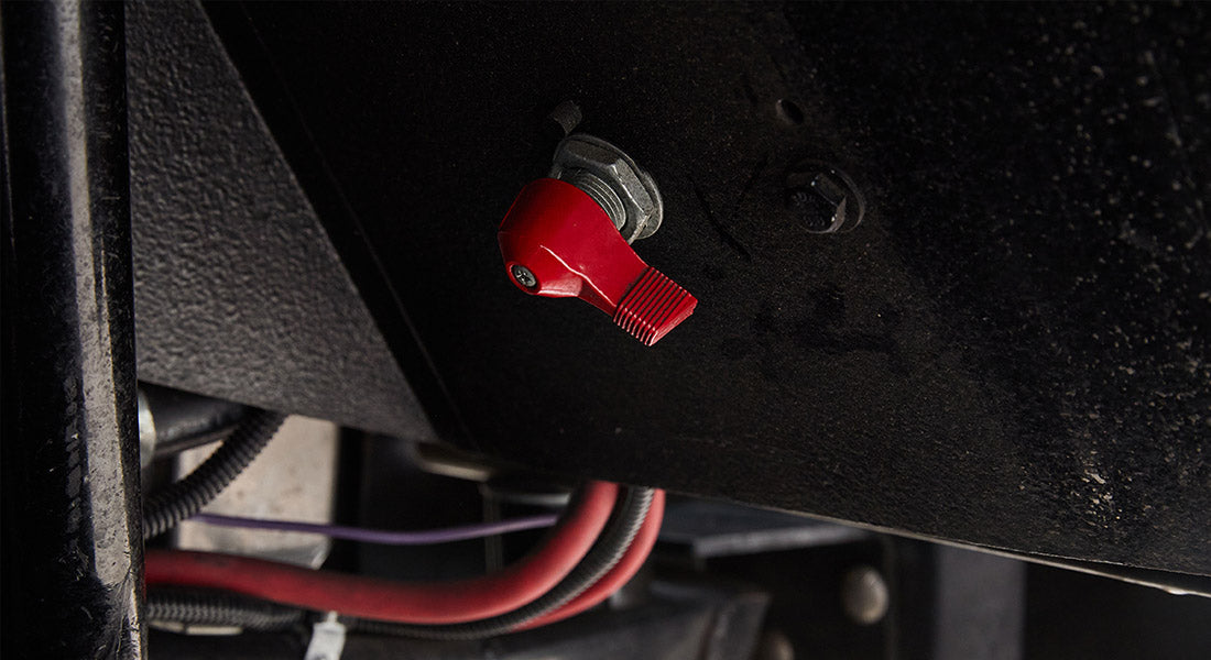 Red toggle switch with wiring mounted under vehicle in Classic Ford Bronco