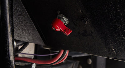Red toggle switch with wiring mounted under vehicle in Classic Ford Bronco