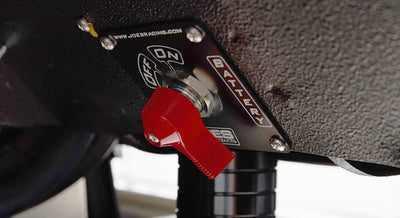 Red battery master switch labeled on/off under dashboard