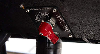Battery disconnect switch with red handle mounted inside Classic Ford Bronco.