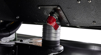Red battery switch labeled OFF/ON BATTERY mounted under Classic Ford Bronco