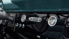 Close-up of Classic Ford Bronco dashboard with black glossy panel and round air vents