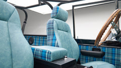 Class Ford Bronco interior with blue plaid and teal leather seats and wooden steering wheel