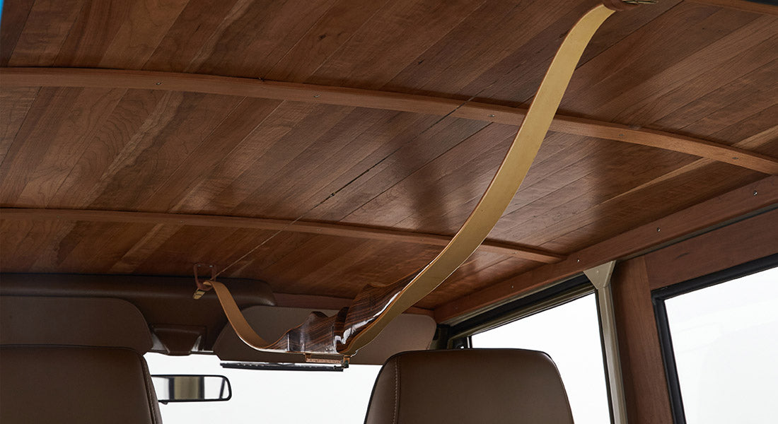 Interior ceiling of Classic Ford Bronco with wood paneling and a mounted wooden bow