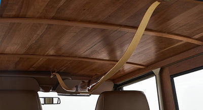 Interior ceiling of Classic Ford Bronco with wood paneling and a mounted wooden bow