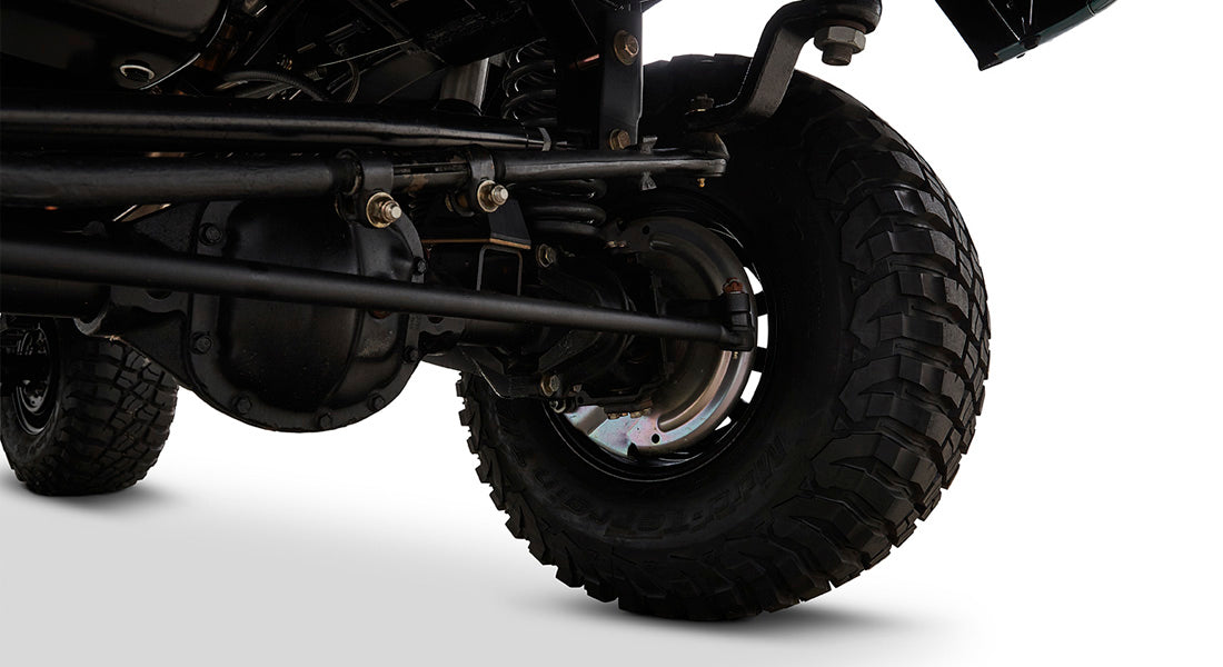 Close-up of Classic Ford Bronco brake assembly and tire from underneath vehicle