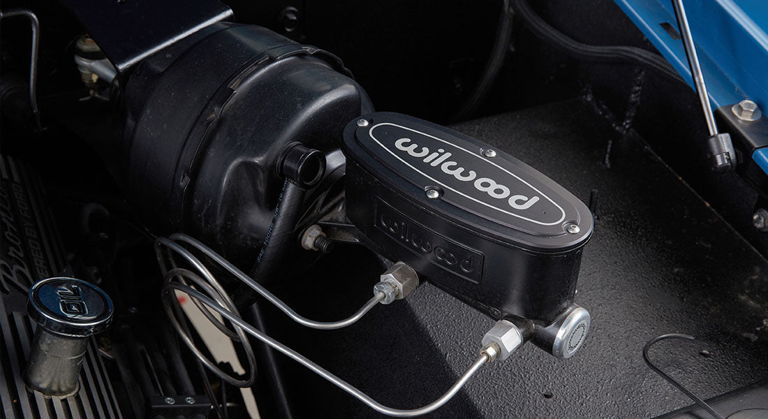 Wilwood branded brake master cylinder and components in engine bay of Classic Ford Bronco.