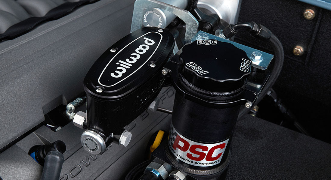 Close-up of Wilwood and PSC branded brake and power steering components in the engine bay of a Classic Ford Bronco