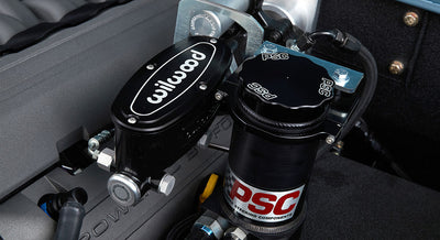 Close-up of Wilwood and PSC branded brake and power steering components in the engine bay of a Classic Ford Bronco