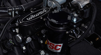 Close-up of black Wilwood brake assembly and PSC steering components in a Classic Ford Bronco engine bay