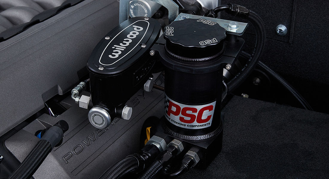 Close-up of black Wilwood component and PSC power steering parts in Classic Ford Bronco engine compartment