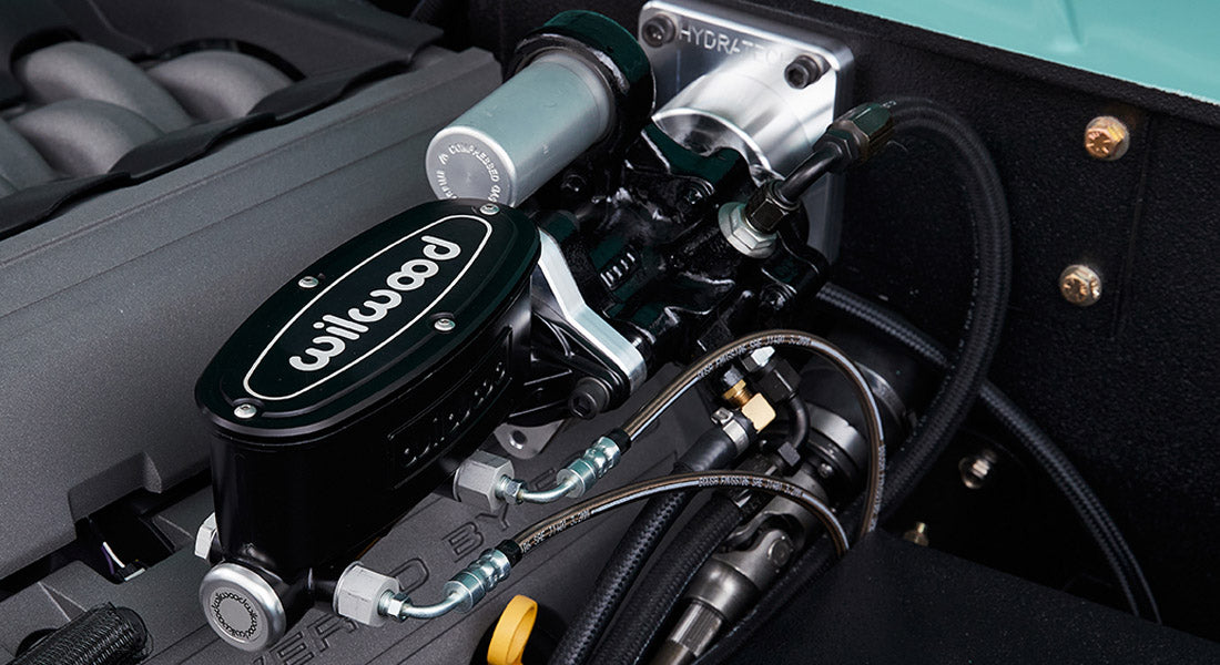 Detailed view of Wilwood branded brake fluid reservoir and engine components in a Classic Ford Bronco.
