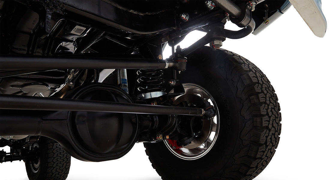 Close-up of Classic Ford Bronco suspension with coil springs and large off-road tires