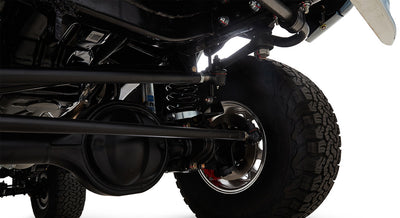 Close-up of Classic Ford Bronco suspension with coil springs and large off-road tires