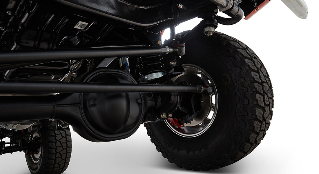 Close-up of Classic Ford Bronco brake assembly and suspension with black differential housing