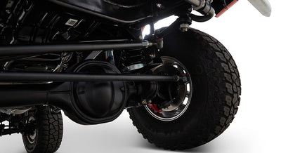 Close-up of Classic Ford Bronco brake assembly and suspension with black differential housing