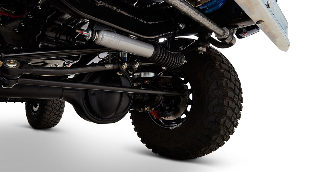 Close-up of rear suspension and tire of Classic Ford Bronco with visible shock absorber and axle