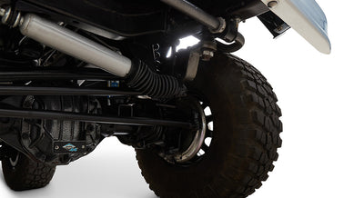 Close-up of wheel, tire, and suspension components of Classic Ford Bronco showing Dana 44 axle