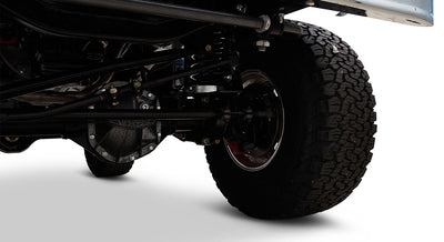 Classic Ford Bronco underside view showing suspension and large off-road tire