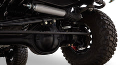 Close-up view of Classic Ford Bronco rear suspension and tire with off-road tread