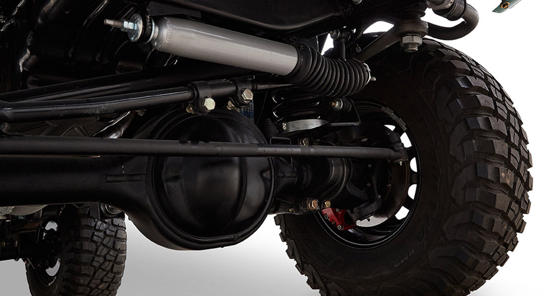 Close-up view of Classic Ford Bronco rear suspension and tire with off-road tread