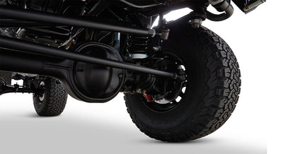 Rear suspension, axle, and tire view of Classic Ford Bronco on white background