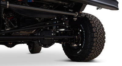Detailed underneath view focusing on tires, axle, and suspension components of a Classic Ford Bronco