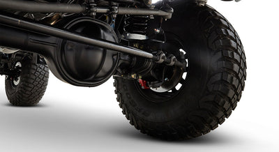 Close-up of front suspension and large off-road tire on a Classic Ford Bronco