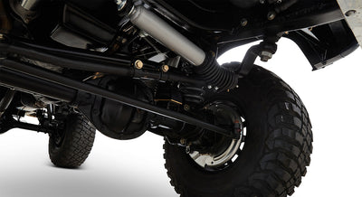 Undercarriage front axle and suspension components of a Classic Ford Bronco with rugged tire