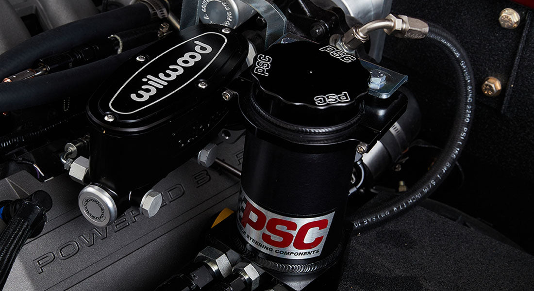 Detail shot of black Wilwood brake component and PSC steering reservoir in Classic Ford Bronco engine bay