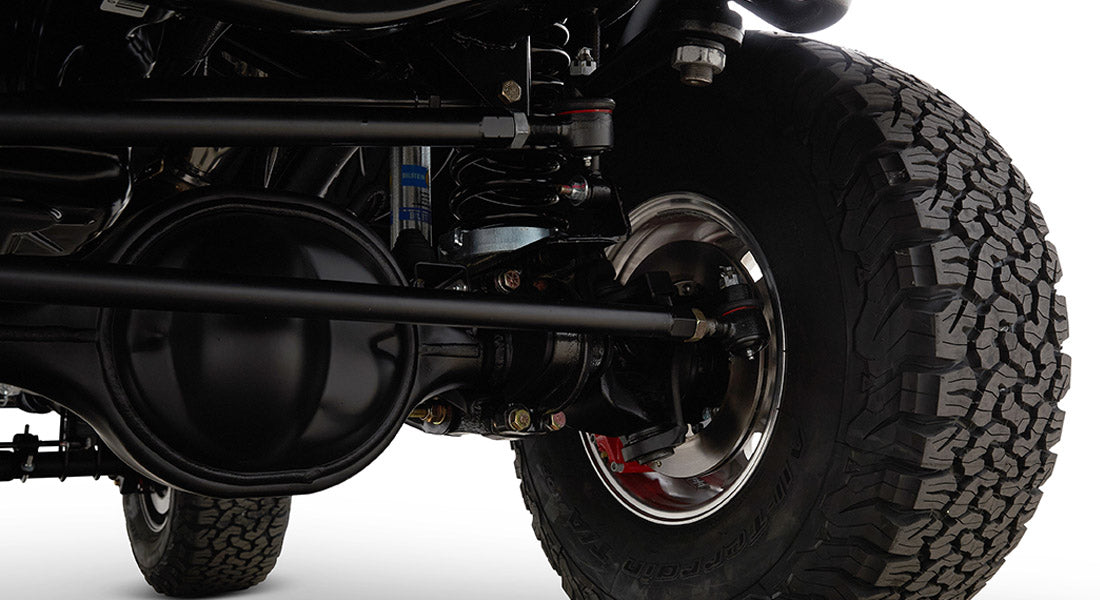 Black suspension and brake components with off-road tire on a Classic Ford Bronco