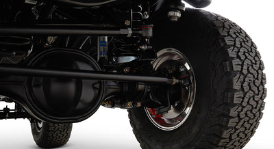 Black suspension and brake components with off-road tire on a Classic Ford Bronco