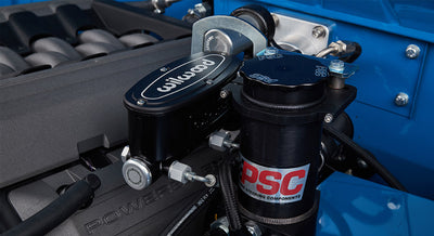 Close-up of Wilwood brake master cylinder and PSC power steering reservoir on Classic Ford Bronco engine