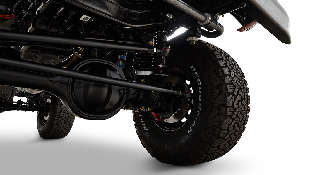Close-up of Classic Ford Bronco suspension and tire undercarriage with off-road tire tread