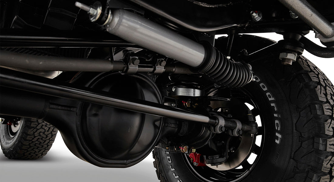 Close-up of vehicle brake and suspension components including tire and shock absorber