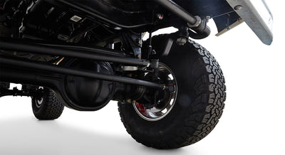 Underbody shot showing black suspension and large off-road tire on Classic Ford Bronco
