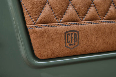 Close-up of brown quilted leather upholstery with CFB Series branding embossed
